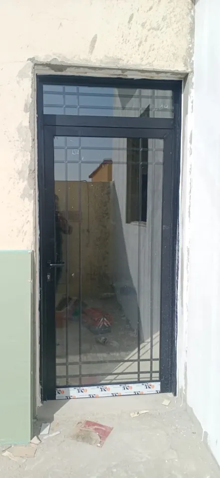 Dark entrance door and transom — Marhaba Aluminium & Metal Works