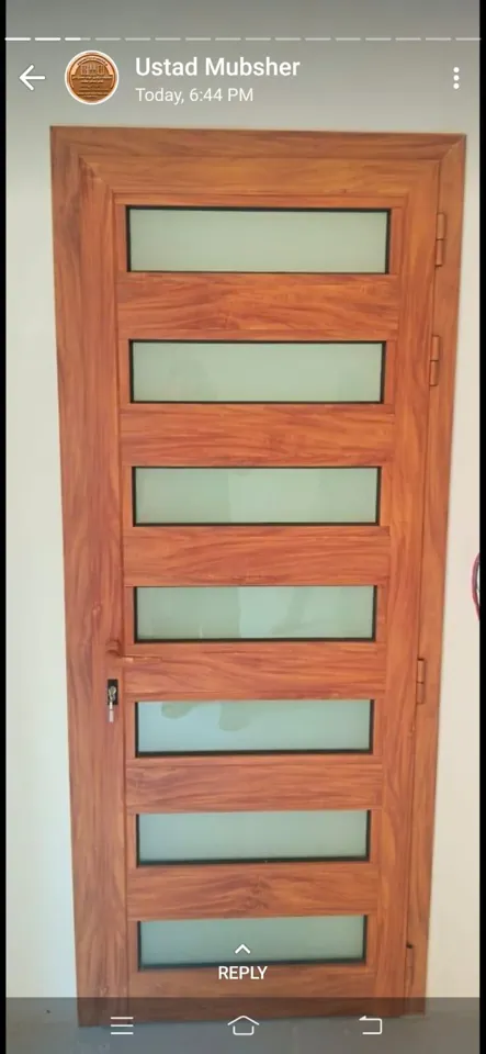 Wood-tone door with glass inserts — Marhaba Aluminium & Metal Works