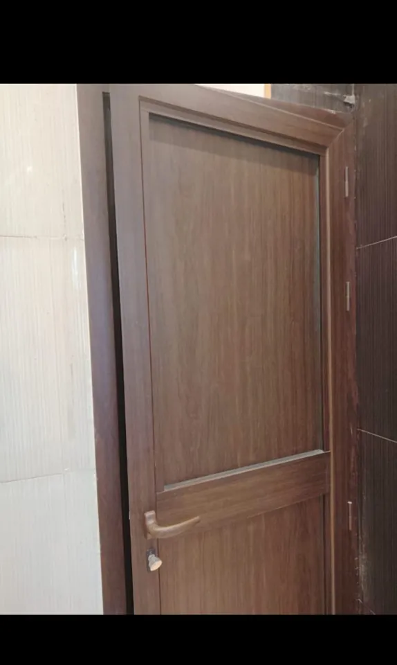 Wood-tone entrance door — Marhaba Aluminium & Metal Works