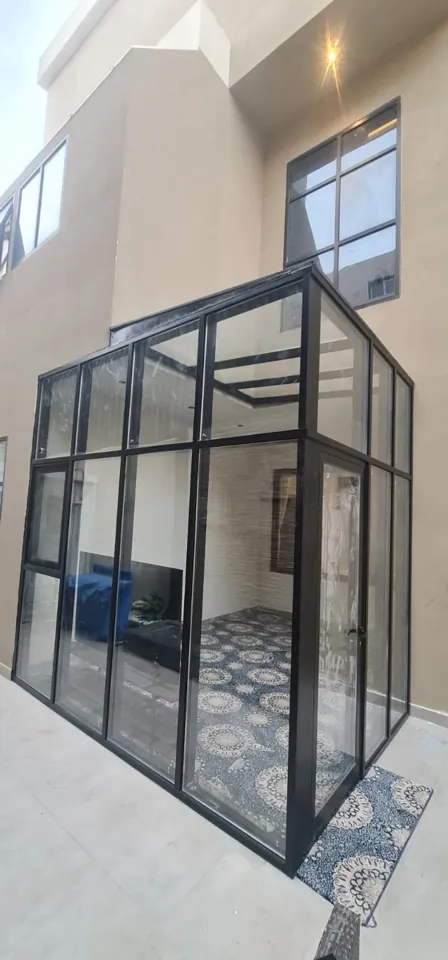 Black-frame exterior glass enclosure — Marhaba Aluminium & Metal Works