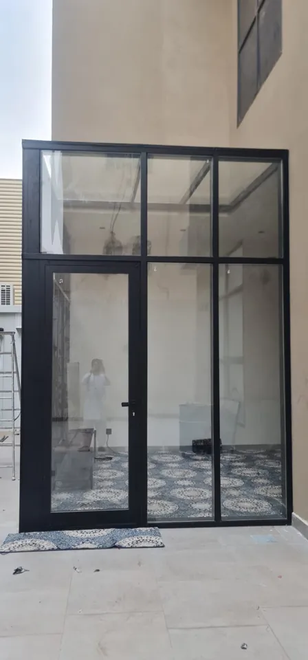 Black-frame glass entry enclosure — Marhaba Aluminium & Metal Works