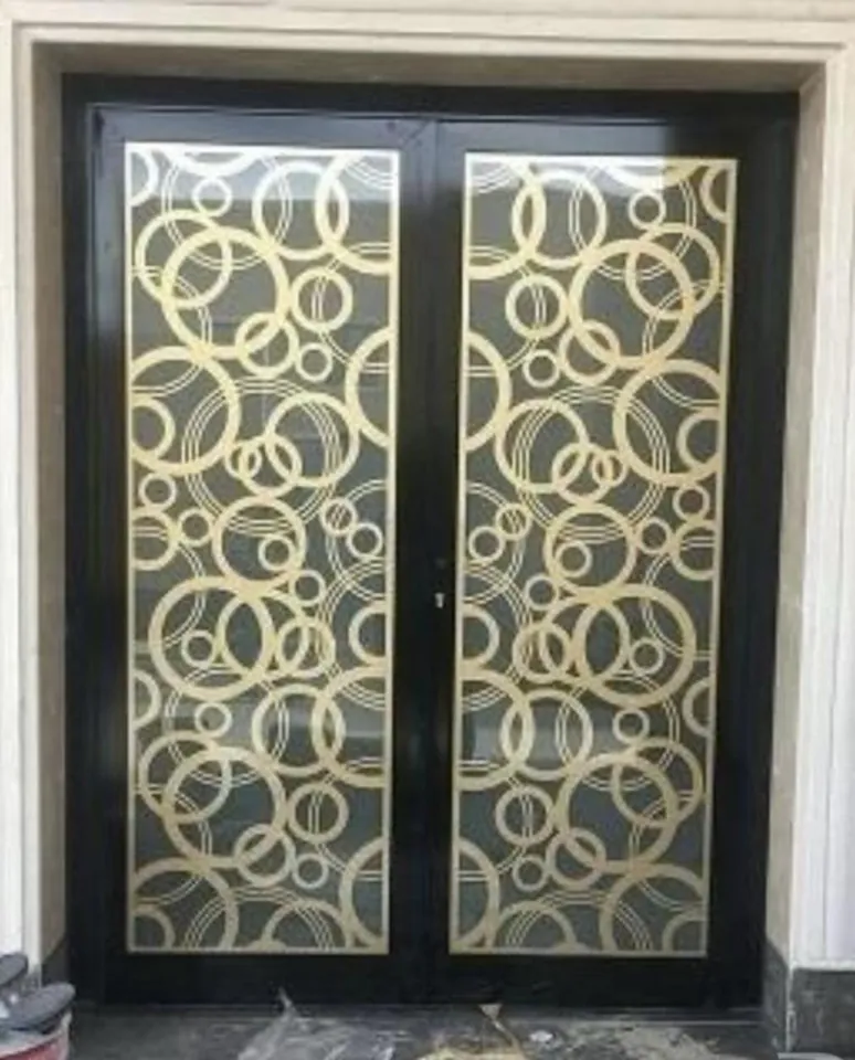 Gold-tone decorative double doors — Marhaba Aluminium & Metal Works