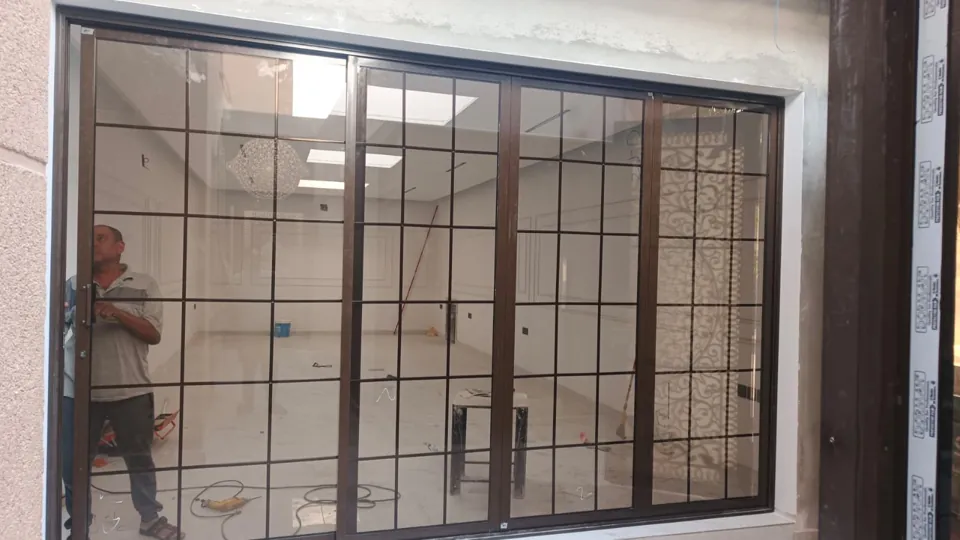 Wide window with protective grille — Marhaba Aluminium & Metal Works
