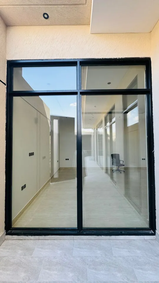 Black-frame picture window — Marhaba Aluminium & Metal Works